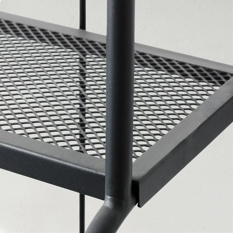 Perforated metal shelf on sturdy black metal frame, showcasing quality craftsmanship and design.