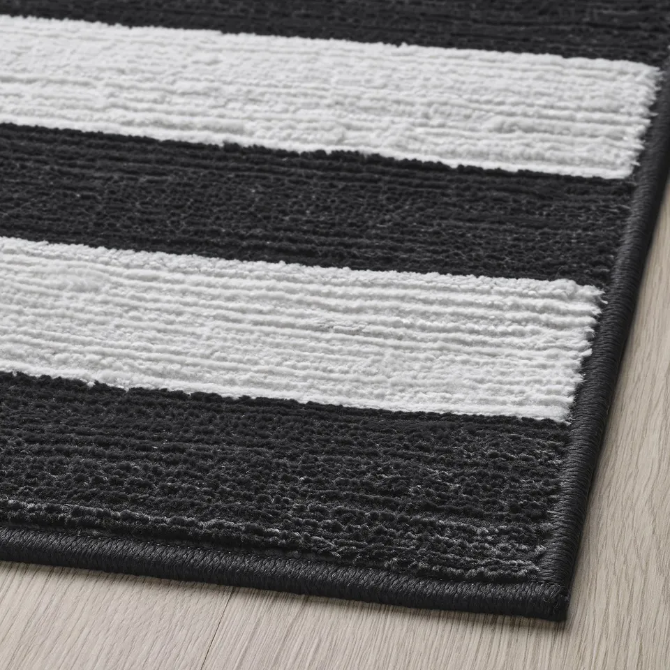 Black and white striped rug closeup, showing soft texture and quality craftsmanship.