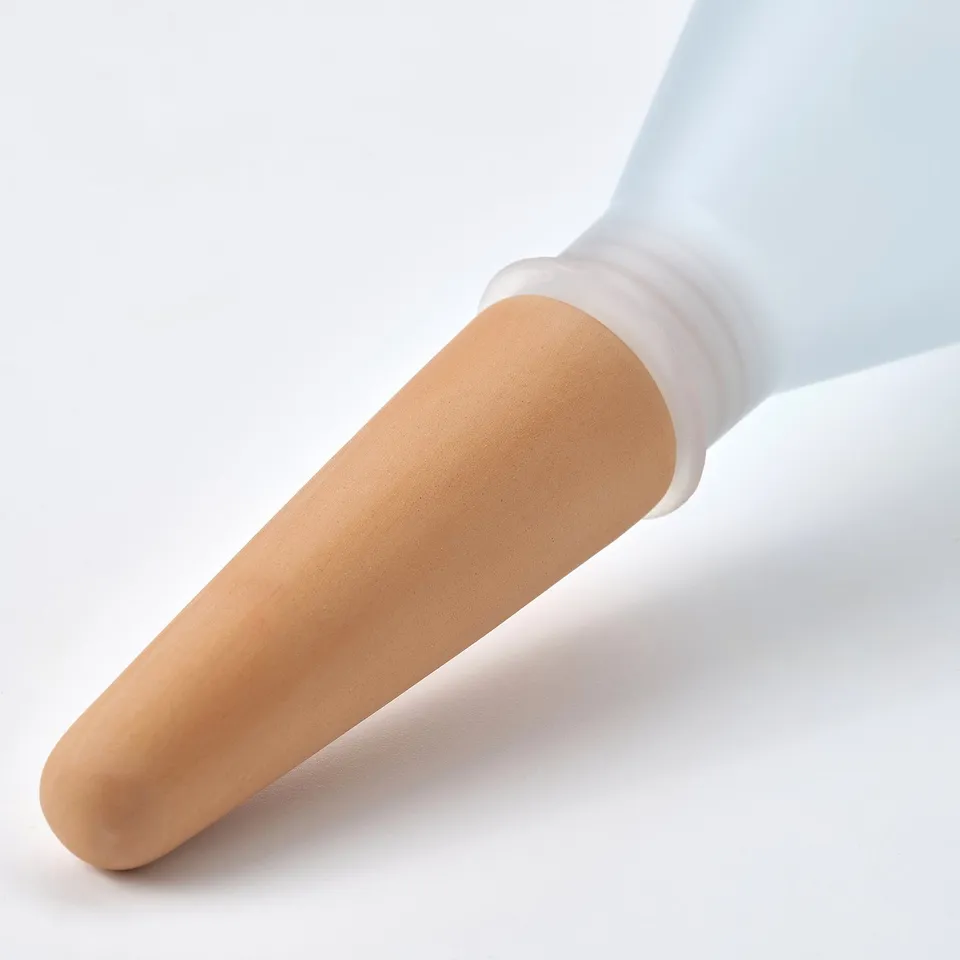 Close-up of self-watering plant insert in terracotta and white.