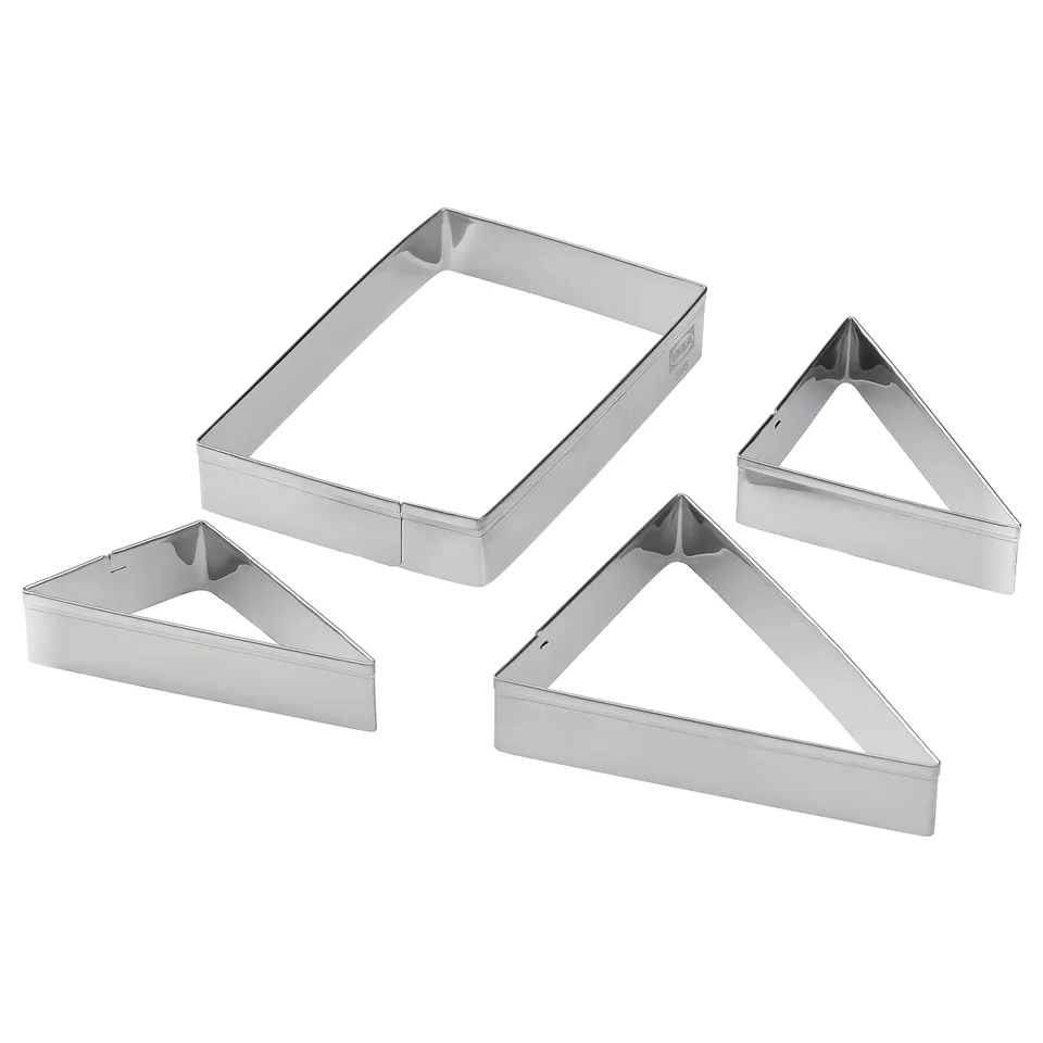 Four chrome-colored metal cookie cutters in rectangular and triangular shapes, designed for baking various shapes and sizes of cookies.