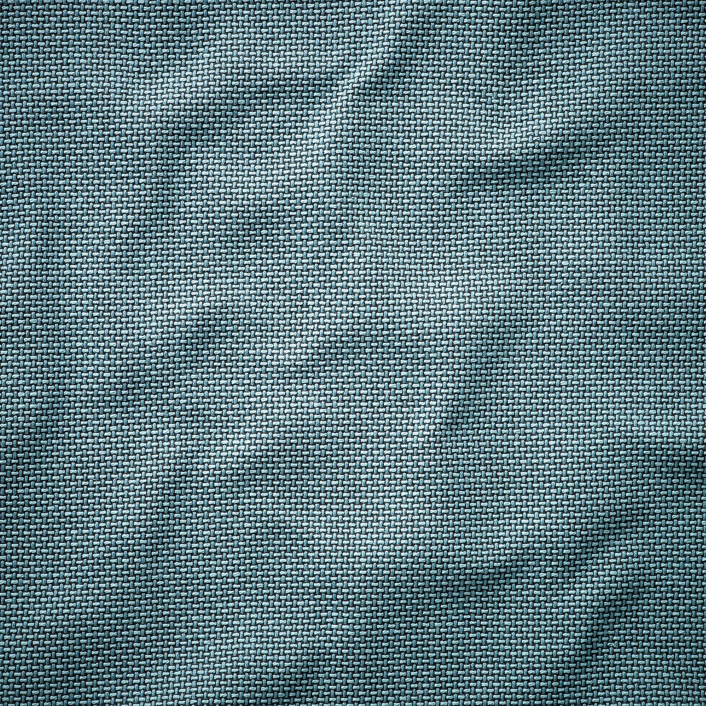 Close-up of woven fabric with varying shades of grey, showcasing a textured, high-quality material.