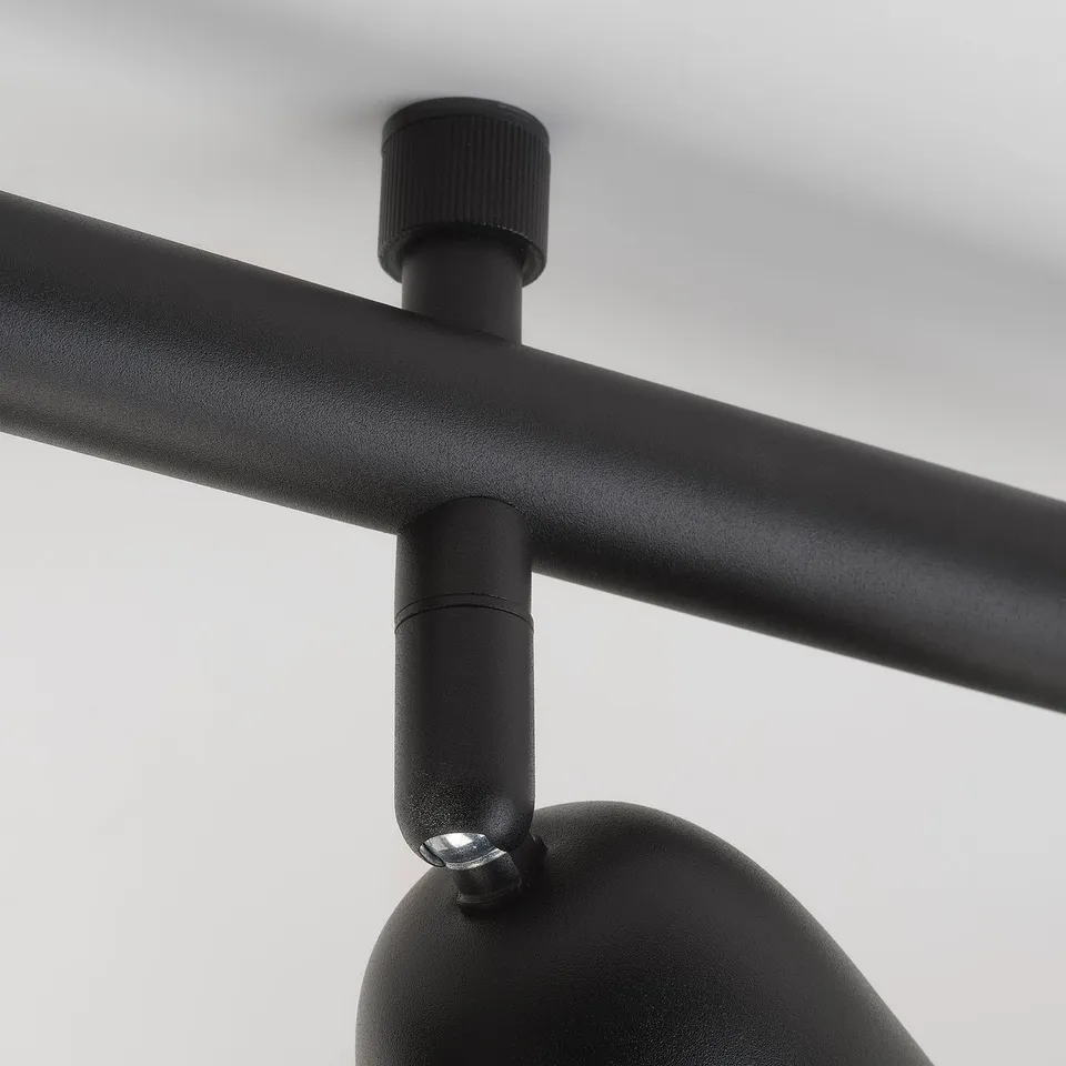 Black metal lamp joint; shows robust, adjustable design.