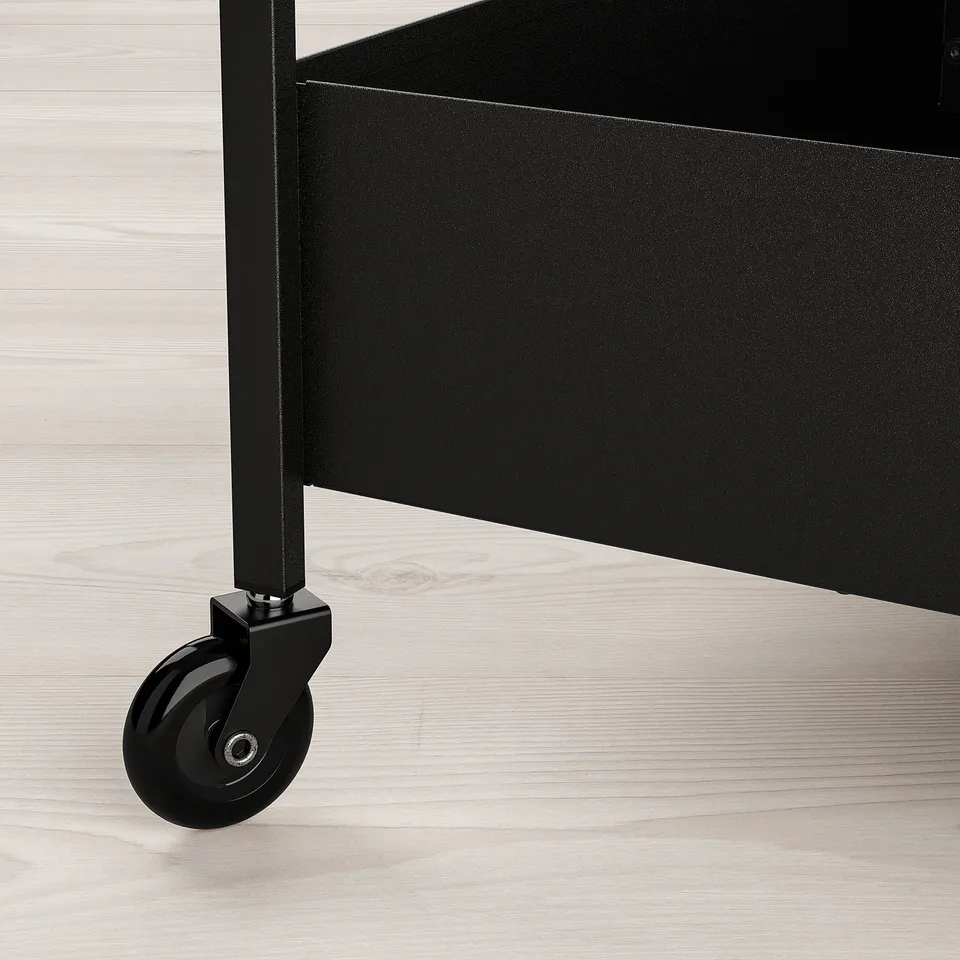 Black metal trolley with a wheel on a light wooden floor, showcasing quality materials and design.
