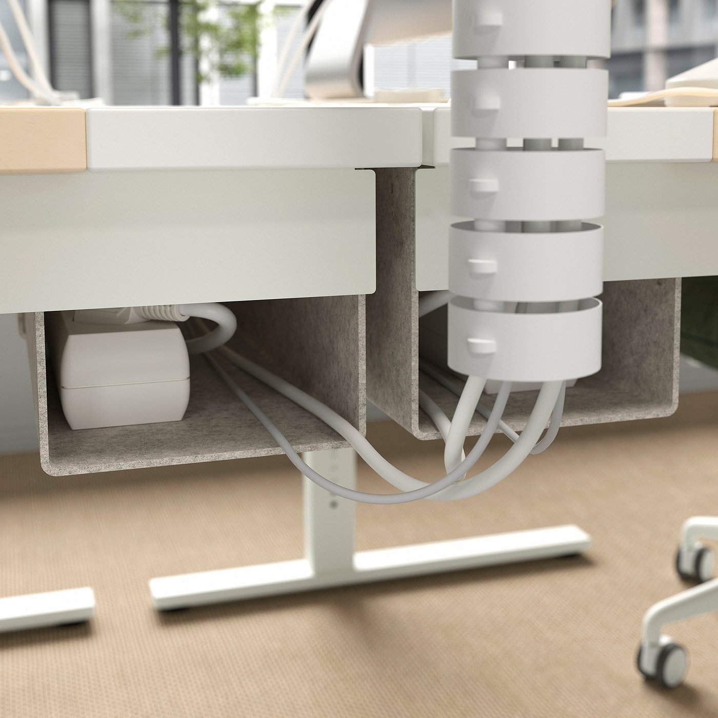 Underside of MITTZON sit/stand desk with cable management tray, showing power source and height adjustment controls.