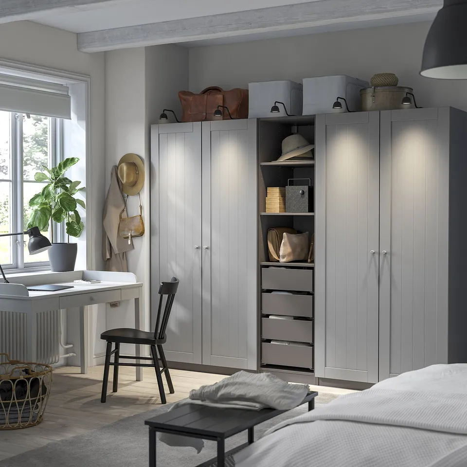 Large white PAX wardrobe with drawers, shelves, housing accessories. Sleek modern design for organising clothes and items.