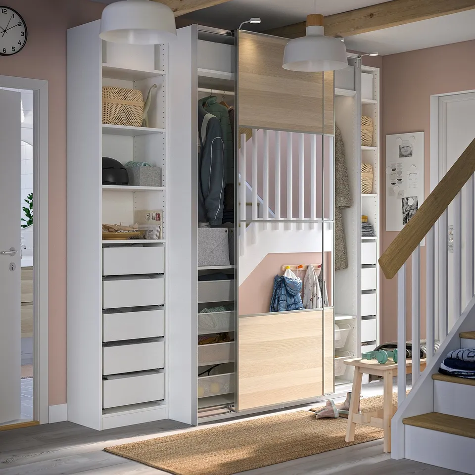 Modern, white and light wood walk-in closet. Sliding doors and organised storage for clothes and accessories.