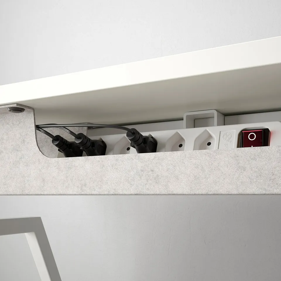 Cable management tray under desk keeps cords organised and tidy.