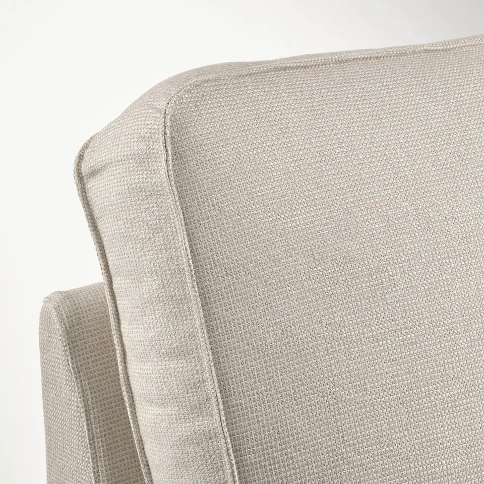 Close-up of high-quality beige KIVIK chaise longue, showcasing plush, textured fabric and expert stitching detail.