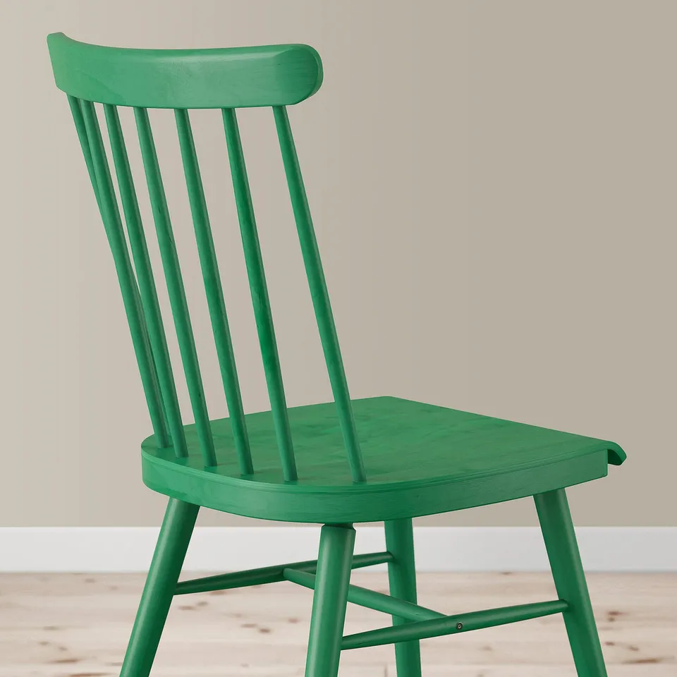 Bright green wooden chair with curved back and seat, sturdy spindle design.
