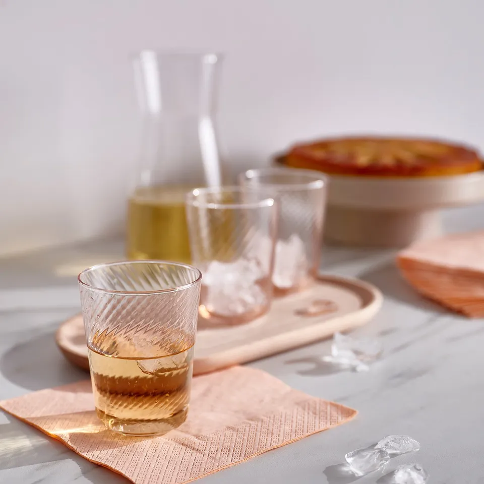 Elegant glassware set: KLIPPLAX glasses, carafe, and dish near light.