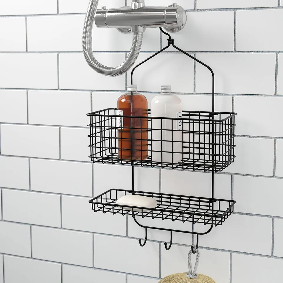 Black wire shower caddy with 2 baskets and hooks, holding bottles and soap.