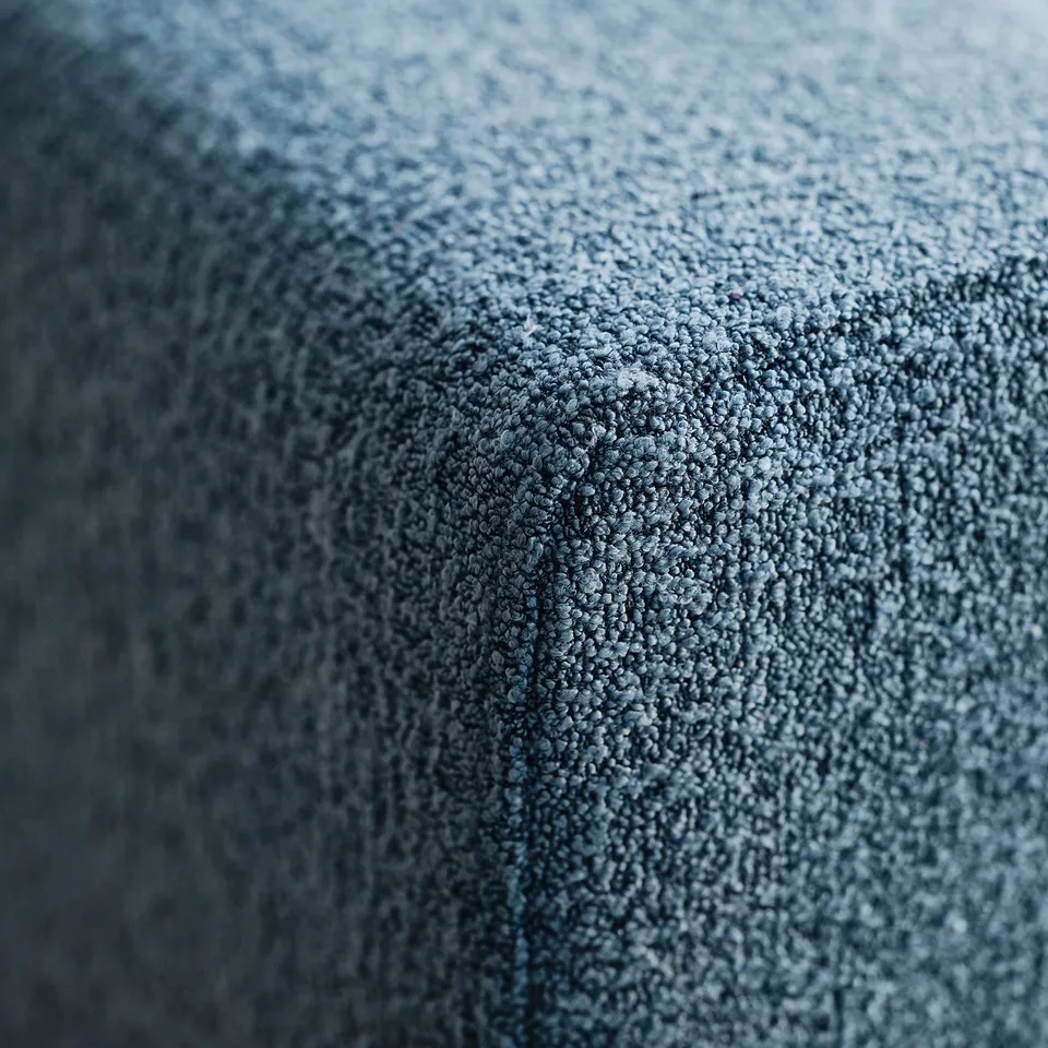 Textured, dark blue fabric close-up, showcasing soft, high-quality material.