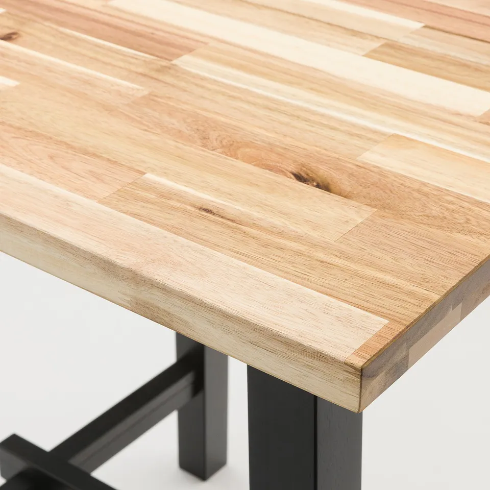Close-up view of a sleek, wooden tabletop with visible grain texture and a smooth finish, supported by sturdy black legs.