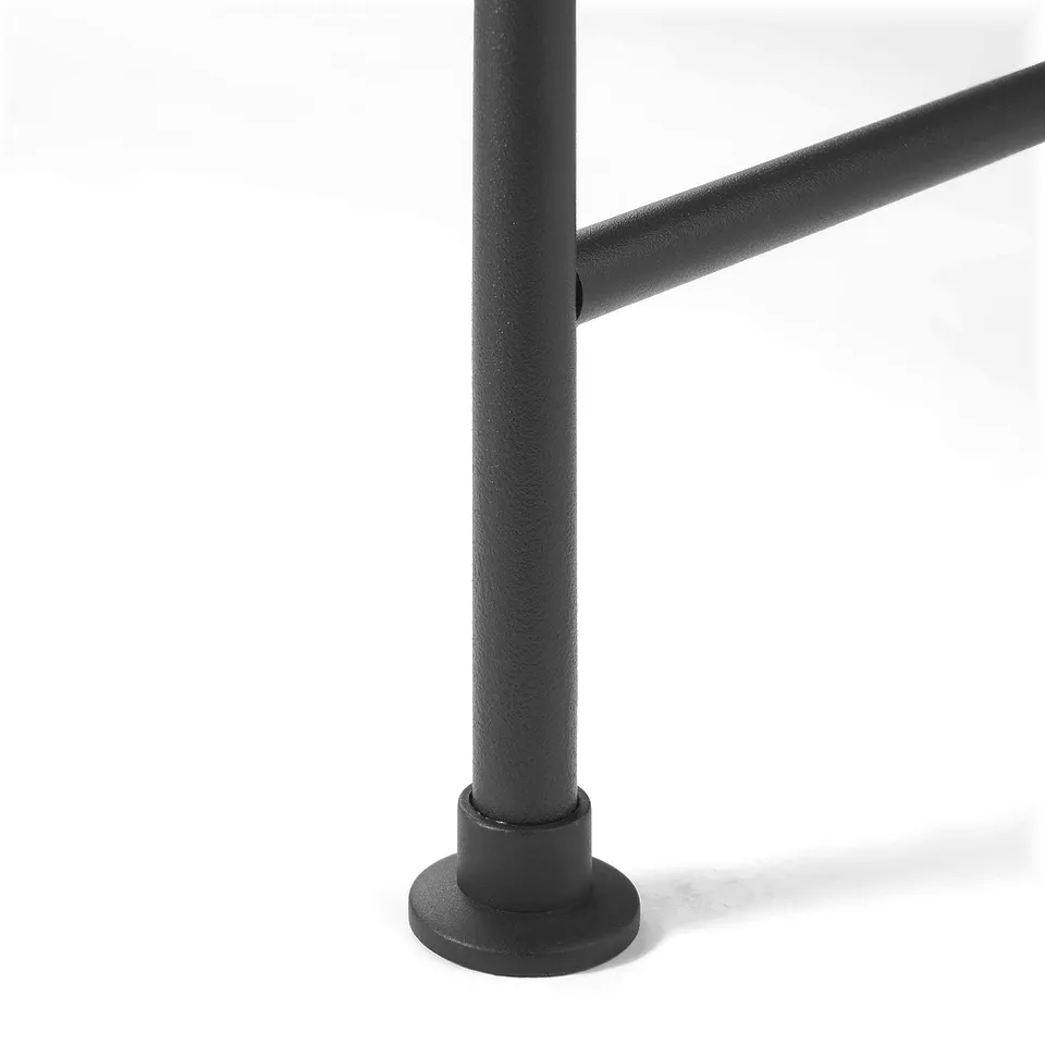 Black metal base of a sturdy bathroom shelf, textured finish for stability.