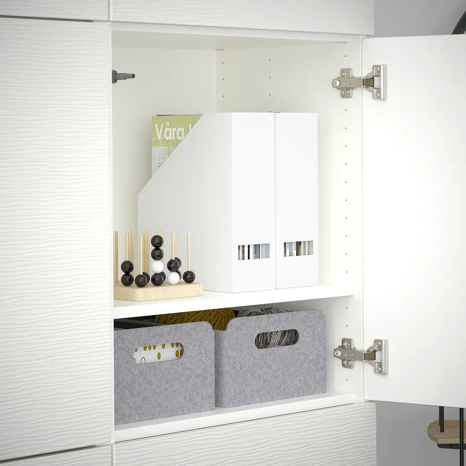 White BESTÅ cabinet with adjustable shelves and soft-close hinges.