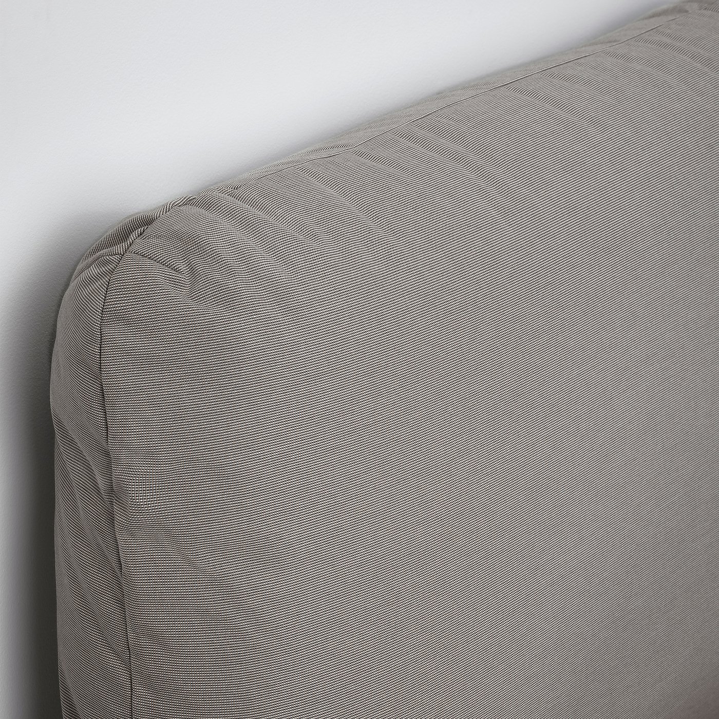 Modern bed with inclined headboard, two soft pillows. Quality upholstery, sleek design.