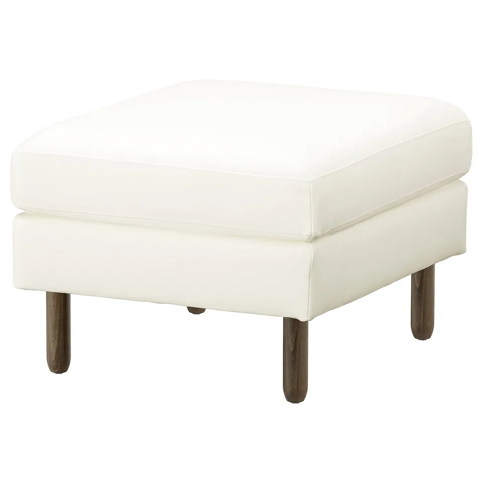 A white SALTSJÖBADEN footstool. It a square shape, padded leather seat, and dark wooden legs. Modern and sleek design.