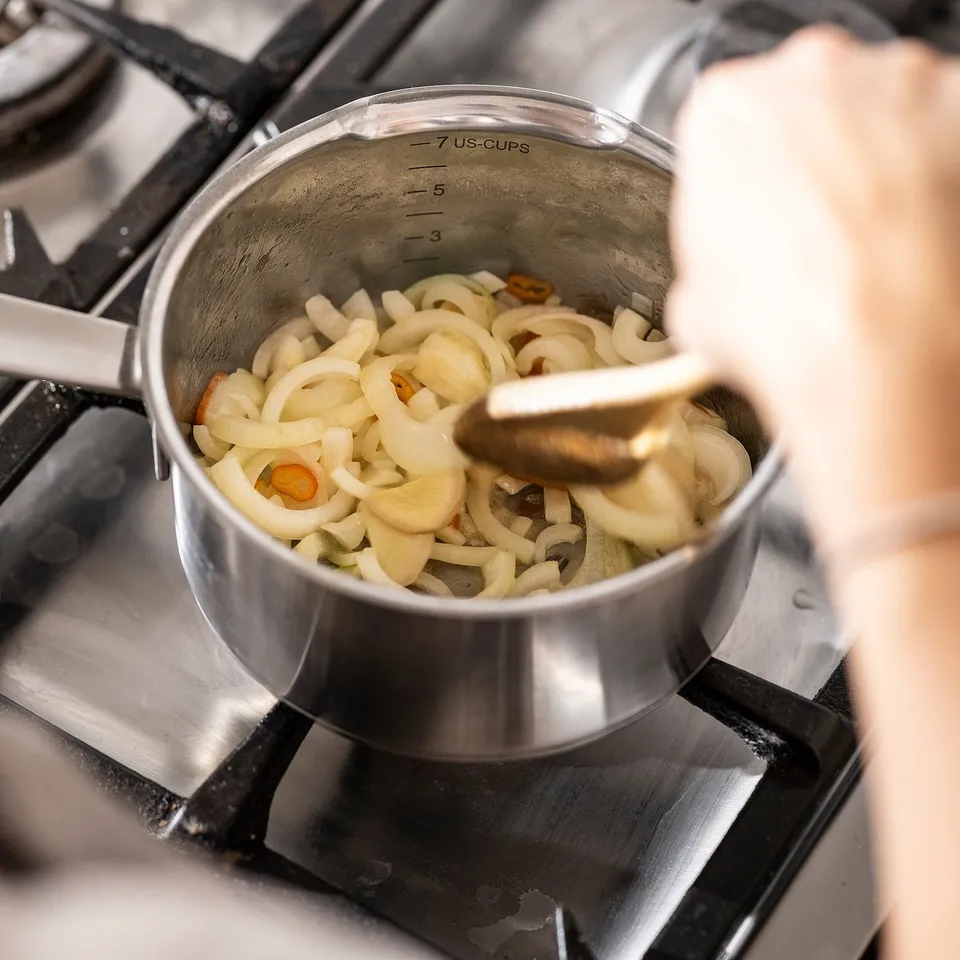 Cooking onions on gas stove.