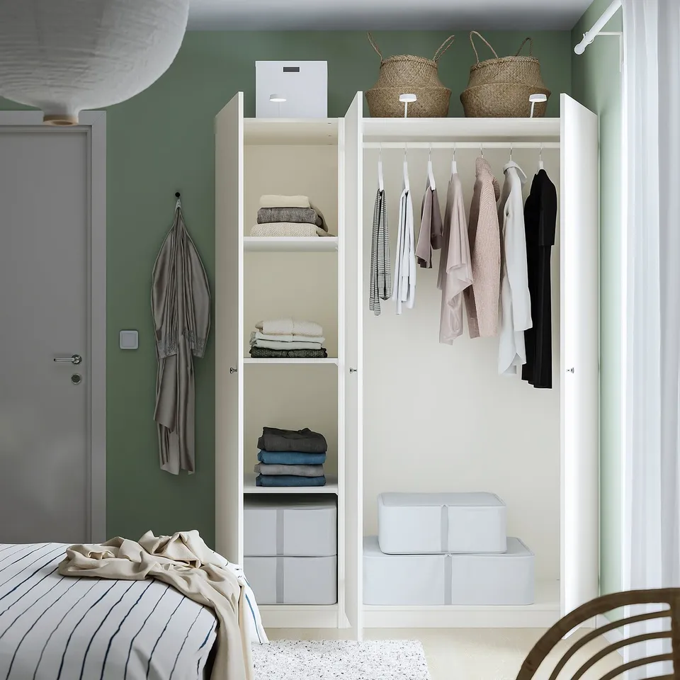 A well-organized closet with neatly folded clothes on shelves and hanging garments, featuring adjustable height and integrated storage boxes.
