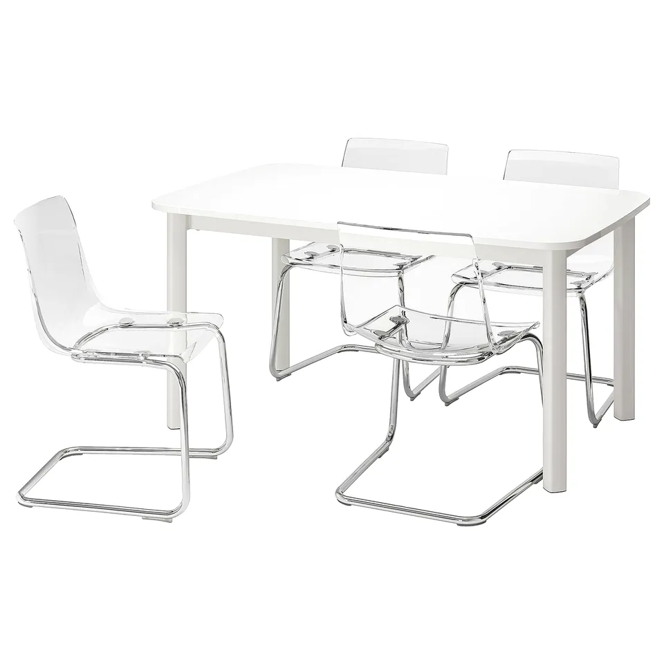 A white IKEA STRANDTORP dining set with a rectangular table and four clear plastic chairs with chrome legs.