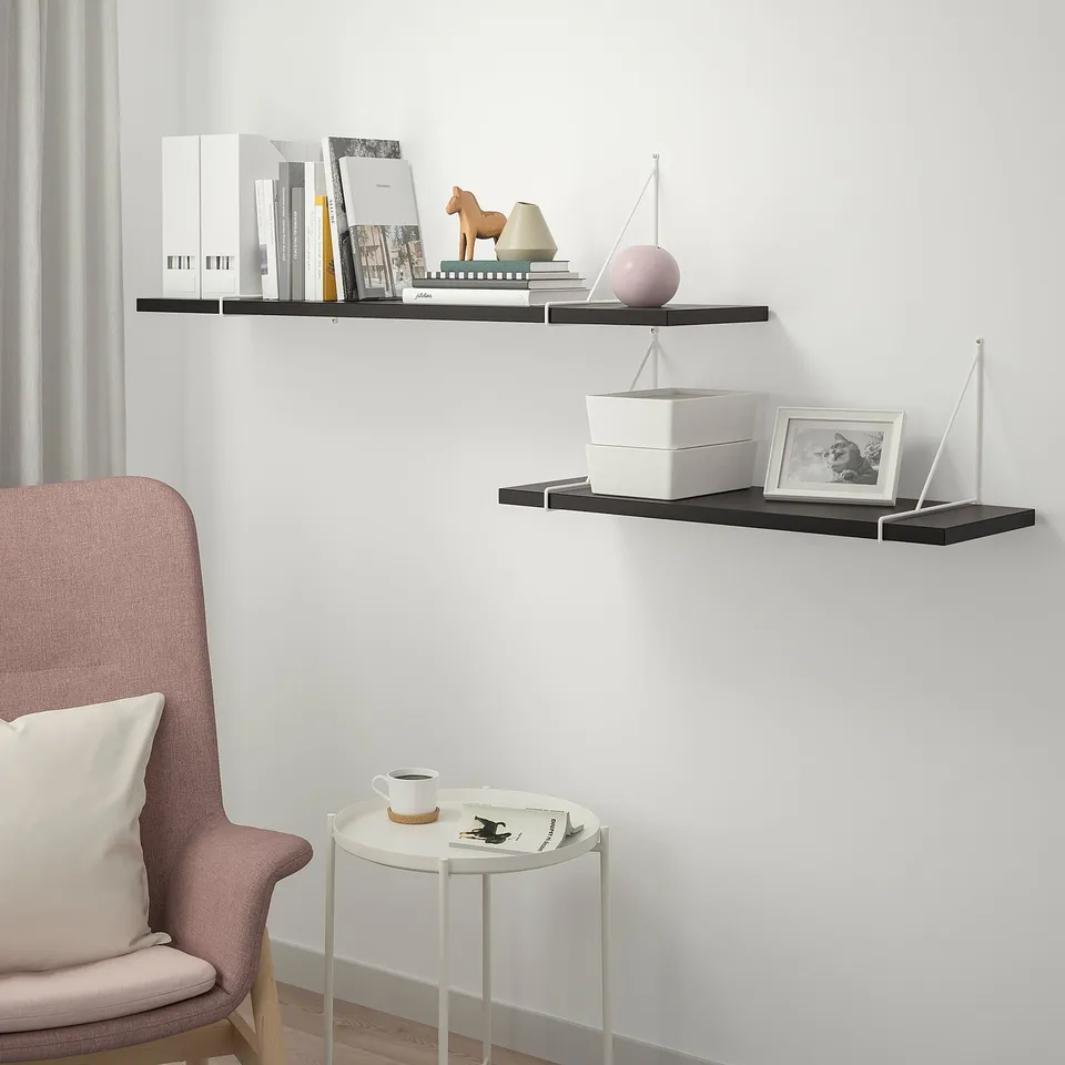 Modern BERGSHULT shelves with books, decor & chair.