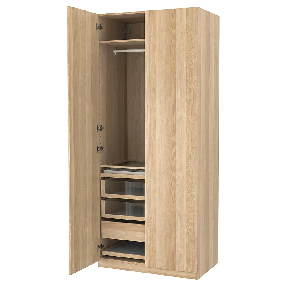 The PAX wardrobe, light wood colour, rectangular shape, hinged doors, drawers, and hanging space.