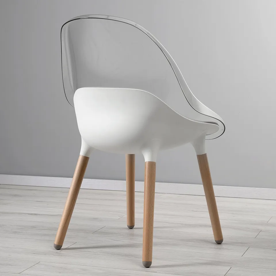 Modern white chair with clear, curved back, sturdy wooden legs, bowl-shaped seat, offers comfort and sleek design.