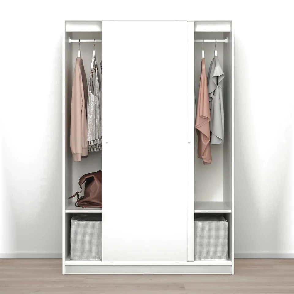 A white KLEPPSTAD wardrobe holds clothes on hangers and shelves, anchored safely to prevent tipping.