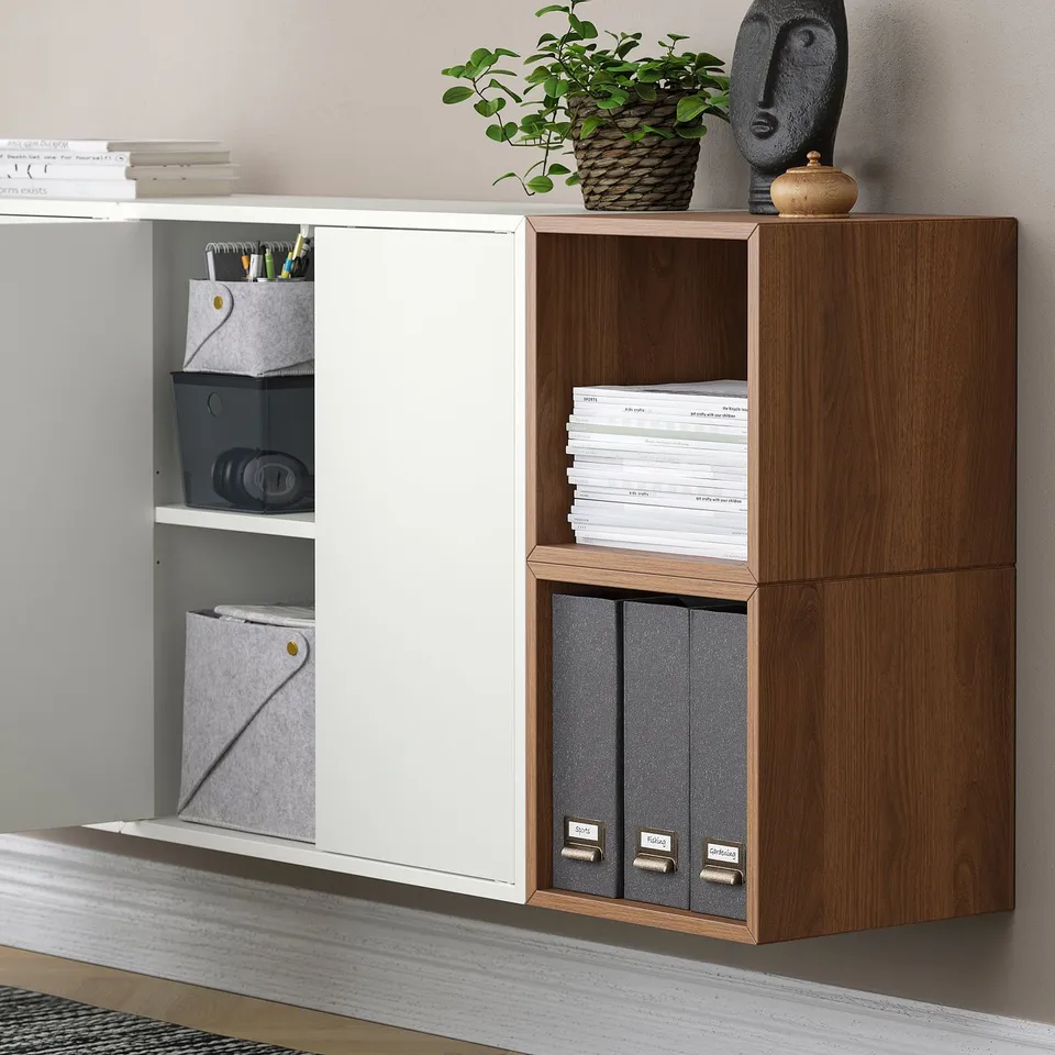 Wall-mounted storage units with mixed open and closed compartments. Shelves hold books, pens, and files. Easy access and versatile organisation.