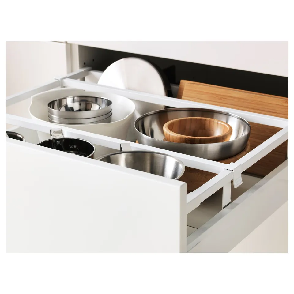 Open kitchen drawer showing organised bowls and lids, part of the METOD system.
