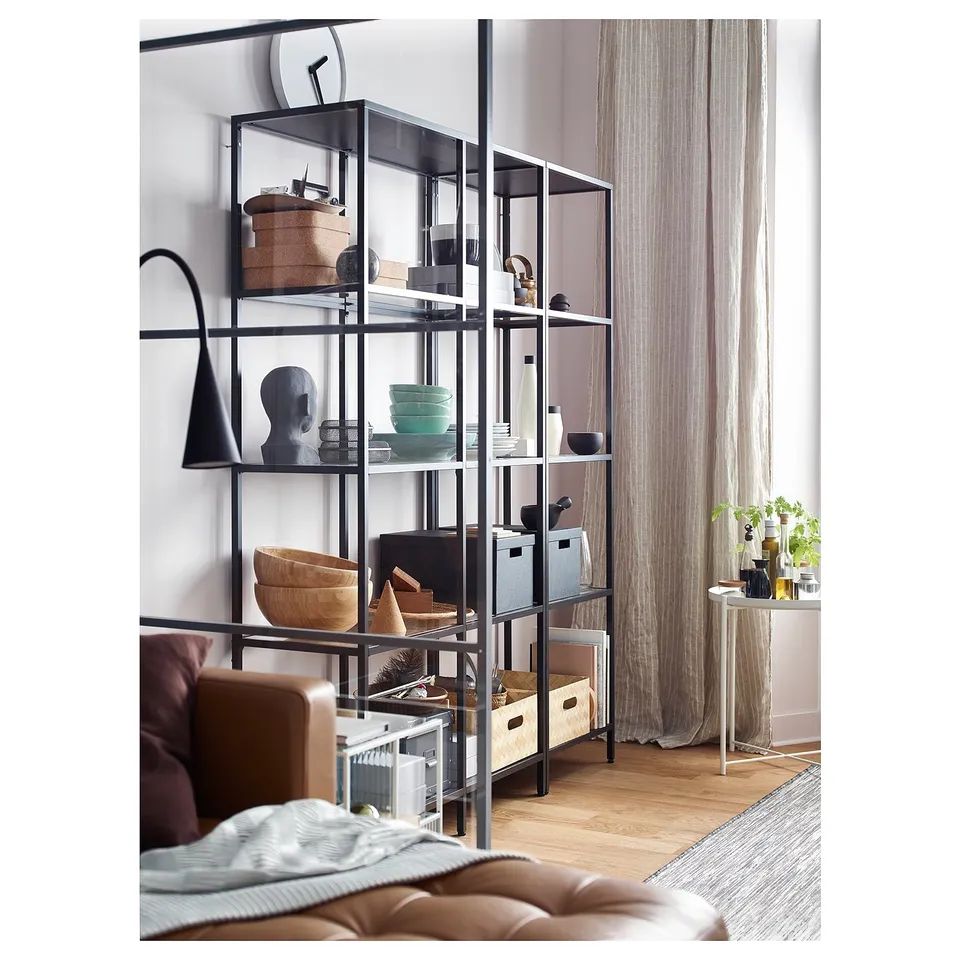 Modern living room with VITTSJÖ shelving unit between sofa and window.