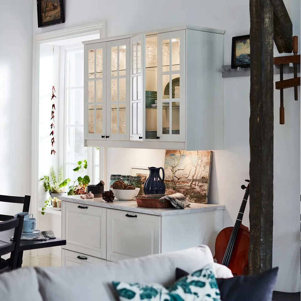 Kitchen: white cabinets, led lights. Blue decor, plants, bear skin wall.