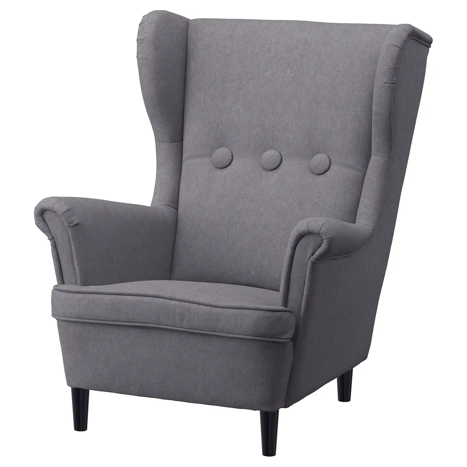 Grey childrens armchair, high back, winged sides, soft cushions.
