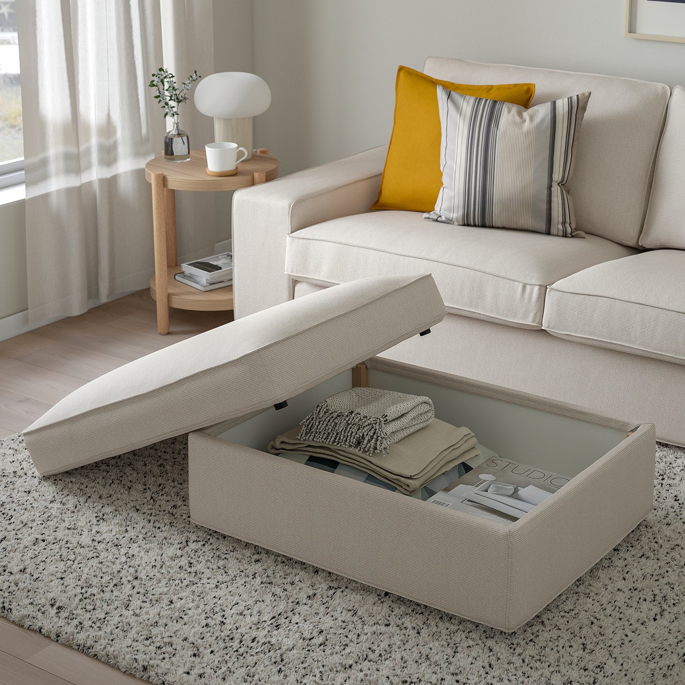 Modern living room with KIVIK footstool, sofa & side table.