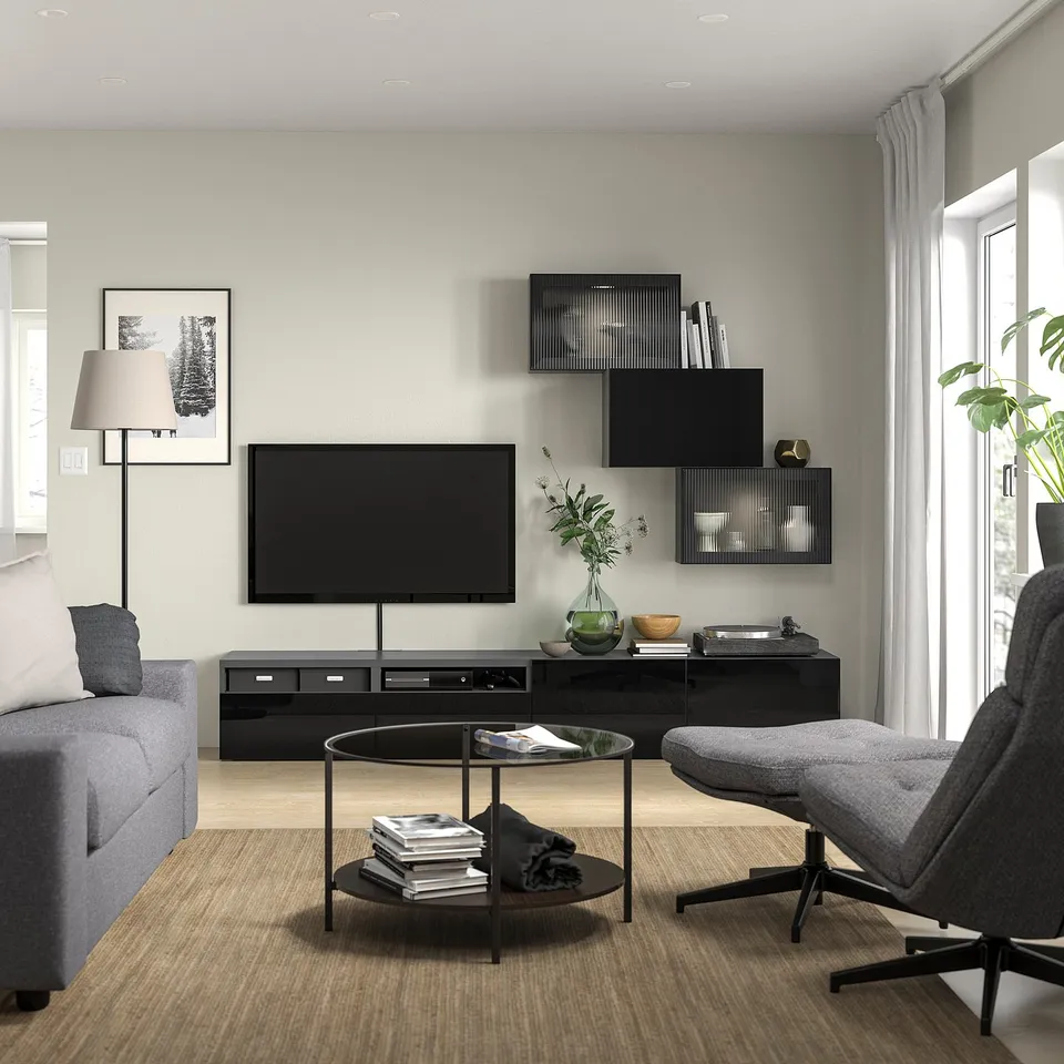 Contemporary living room with sofa, tv, and media unit with lighting.