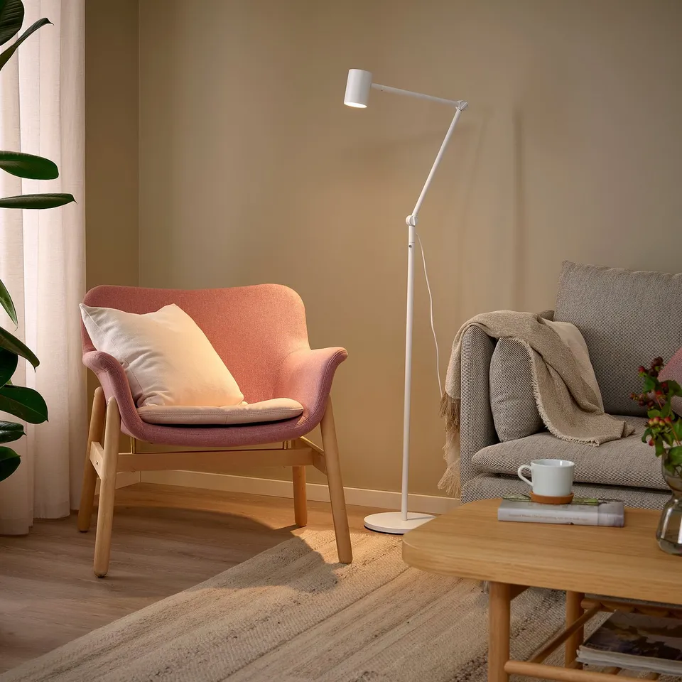 Cosy living room with NYMÅNE lamp, couch, blanket, mug & armchair