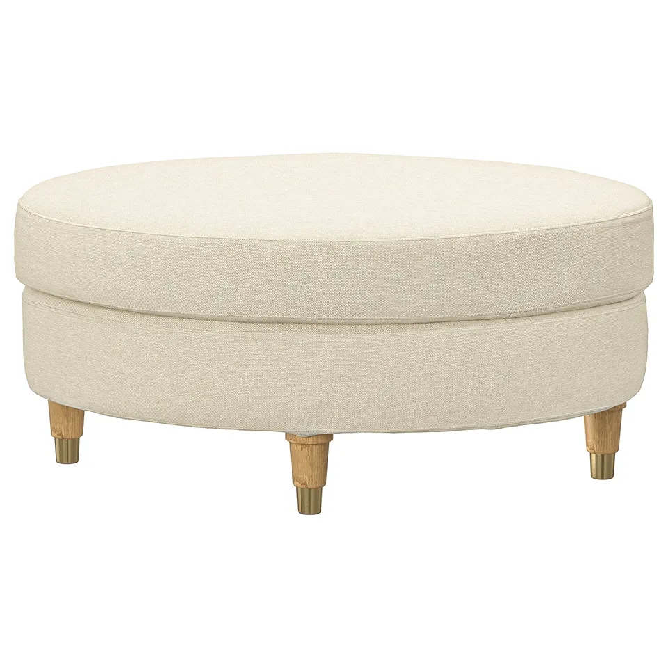 A cream-colored, round ottoman named VALNÄS with wooden legs. Its upholstered in fabric made from cotton and recycled polyester.