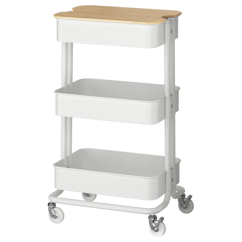 White RÅSKOG storage trolley with bamboo top, four wheels.