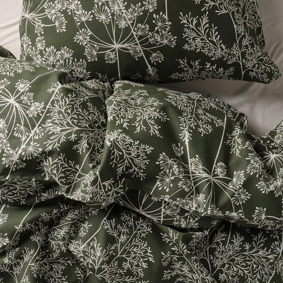 Dark green duvet cover, intricately patterned with white wildflowers, crafted from durable, soft, and breathable cotton-lyocell blend.
