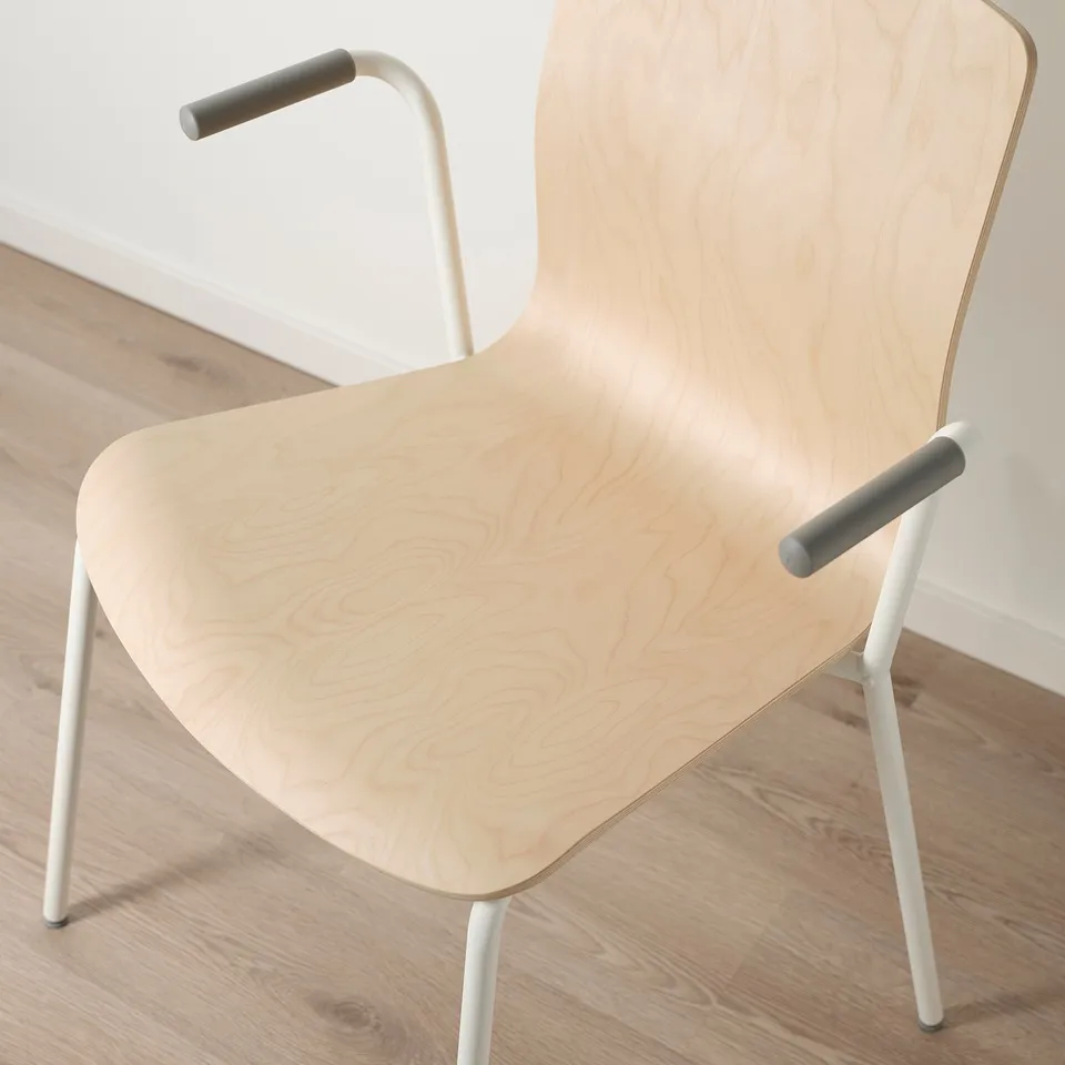 Modern light wood chair with clean design, light birch veneer, white metal legs, and smooth armrests.