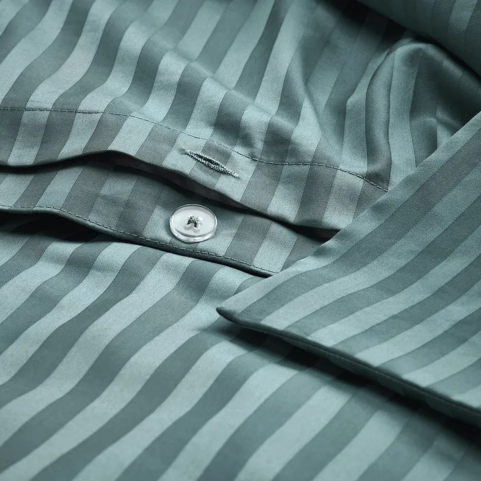 Close-up of striped duvet set in sateen. Button closure shown, 310 thread count.
