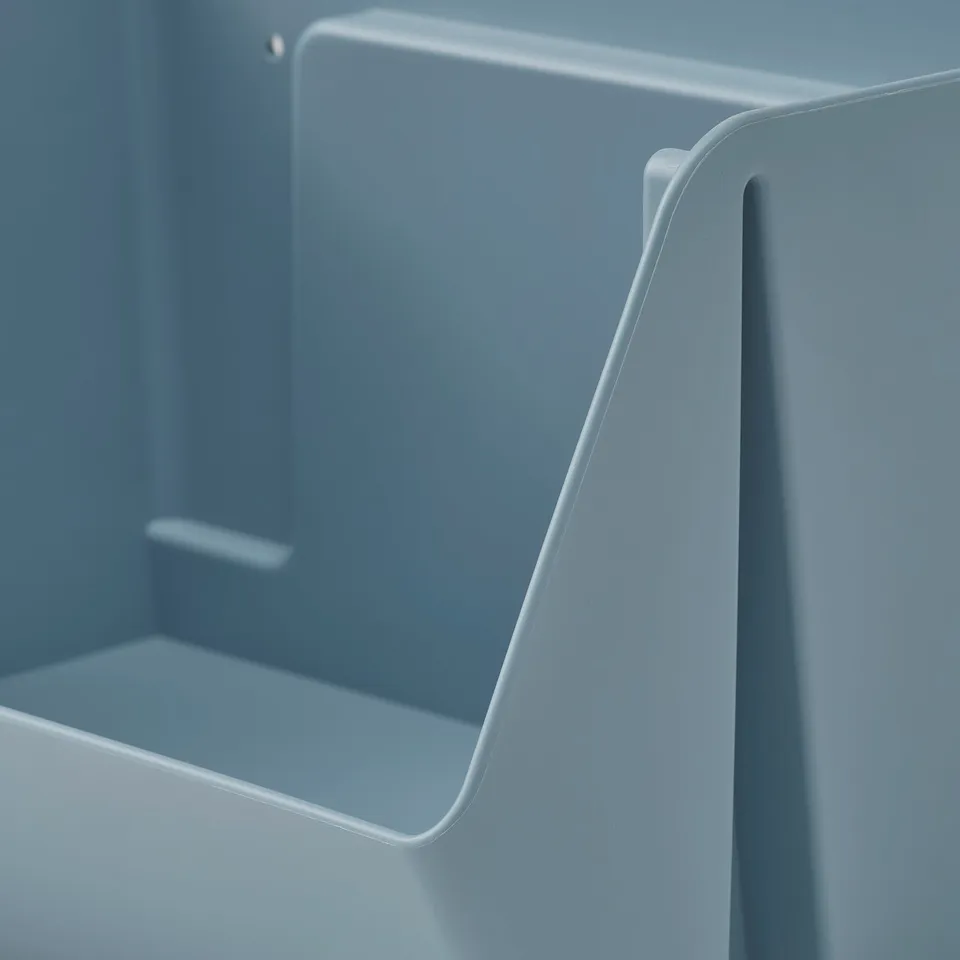 Light grey plastic storage unit, designed for wall mounting or stacking. Sleek, durable, and made from recycled material.