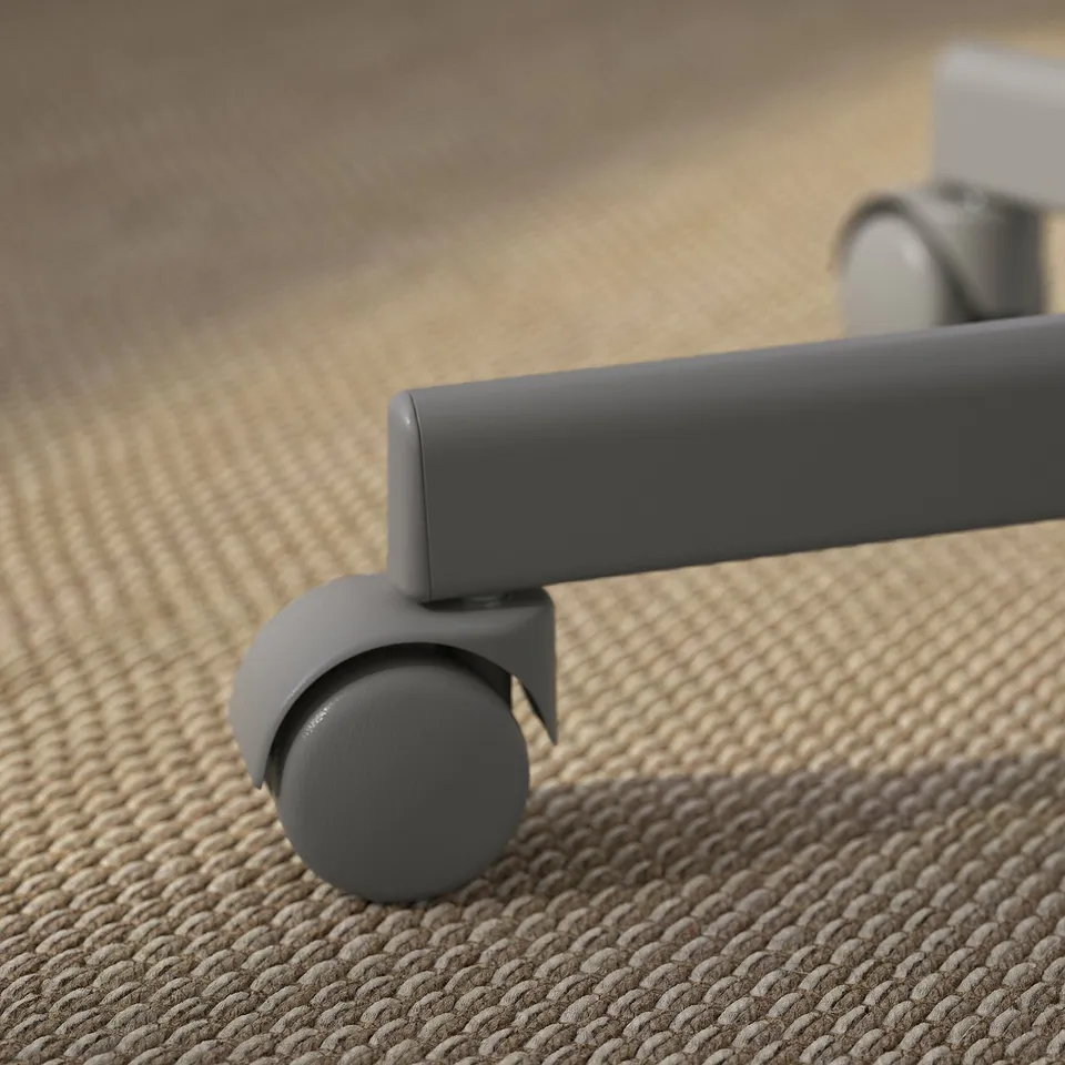 Close-up of a modern office chair wheel, showcasing smooth design and quality materials.