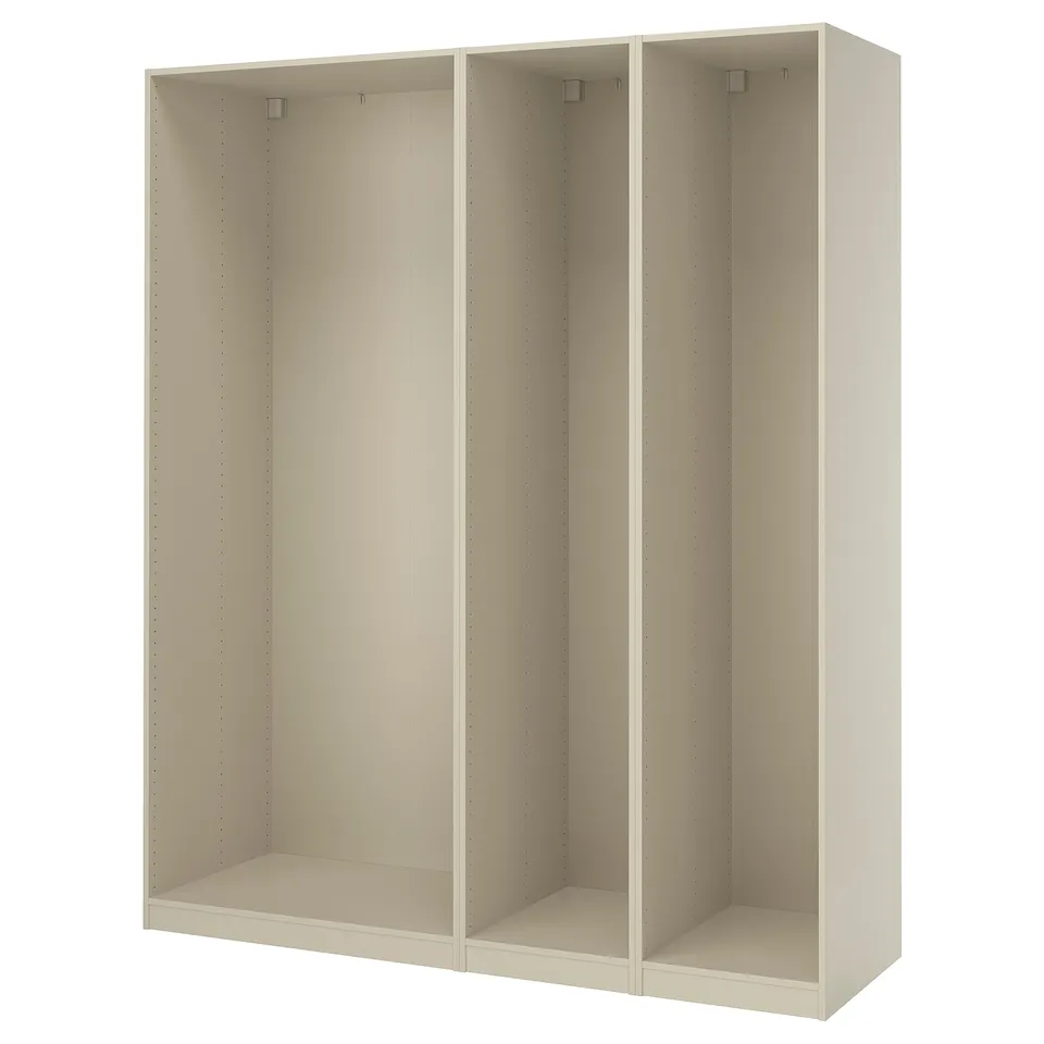 An ikea PAX wardrobe frame in white. It is a tall, rectangular, and modular unit with three sections, each featuring dowels for customizable shelving.