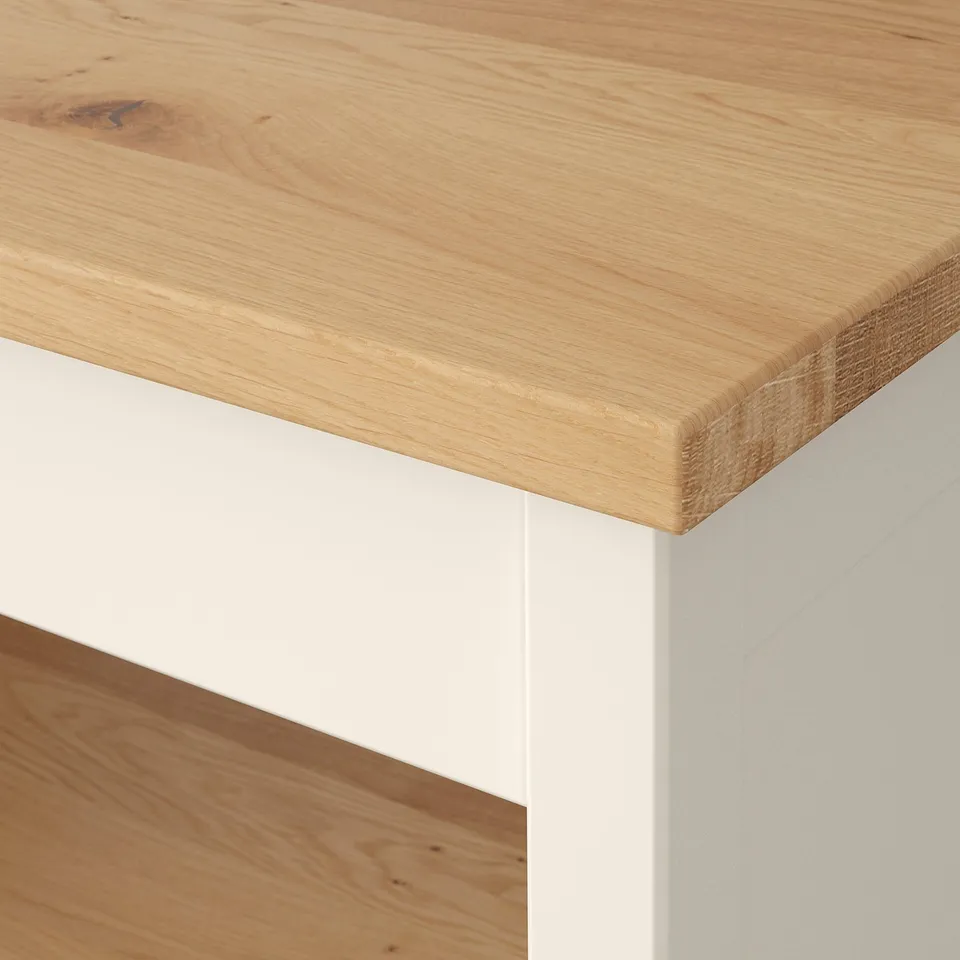 Close-up of a stylish, well-crafted wooden tabletop. Smooth surface with natural grain patterns. Supported by sturdy white legs.
