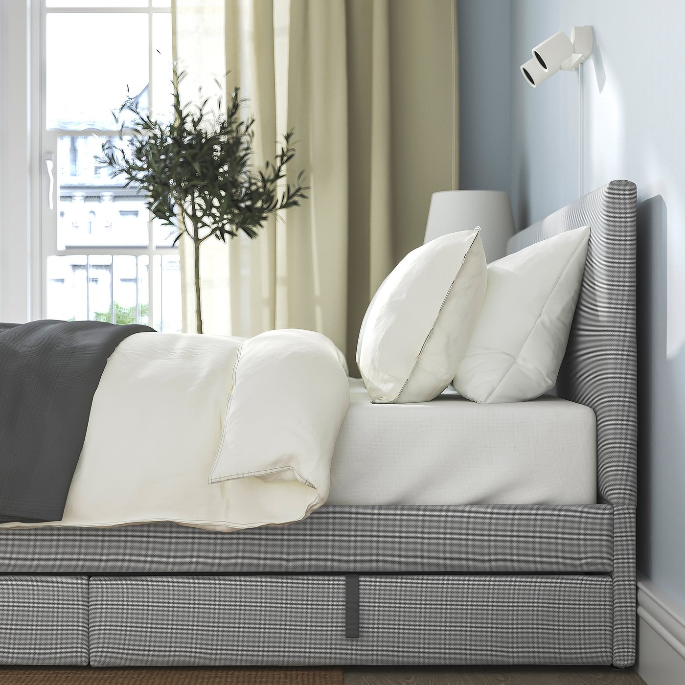 Modern bed with padded headboard 2 storage boxes with castors for easy access, providing both comfort and practical space.