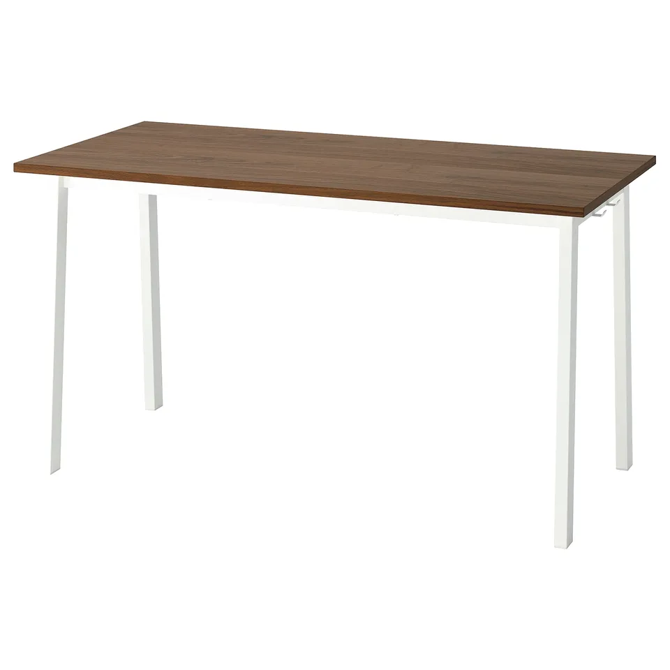 A MITTZON conference table with a wooden top and white metal legs. Its versatile for various workspace setups.