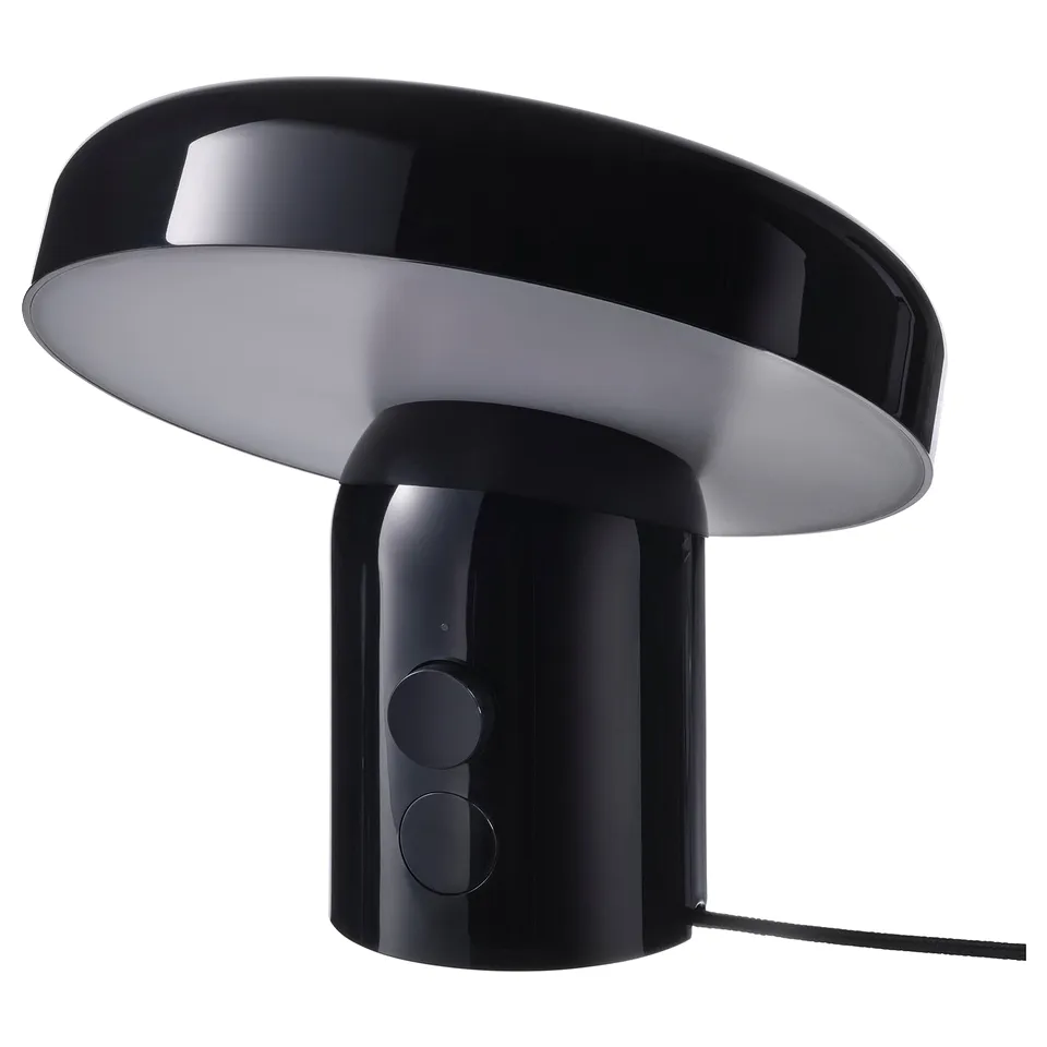 Black BLOMPRAKT speaker-lamp with rounded design, glossy finish, and dimmable light.