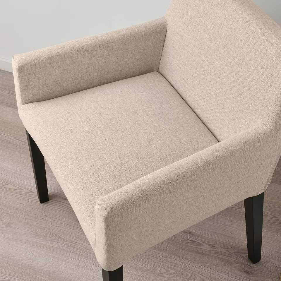 Modern chair with light beige upholstery and black wooden legs, showcasing quality design and comfort.