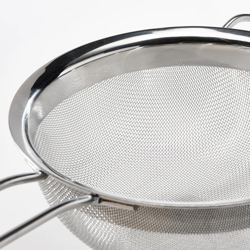 Stainless steel strainer with fine mesh, two sturdy handles, shiny and robust.